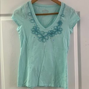 blue top with floral detailing